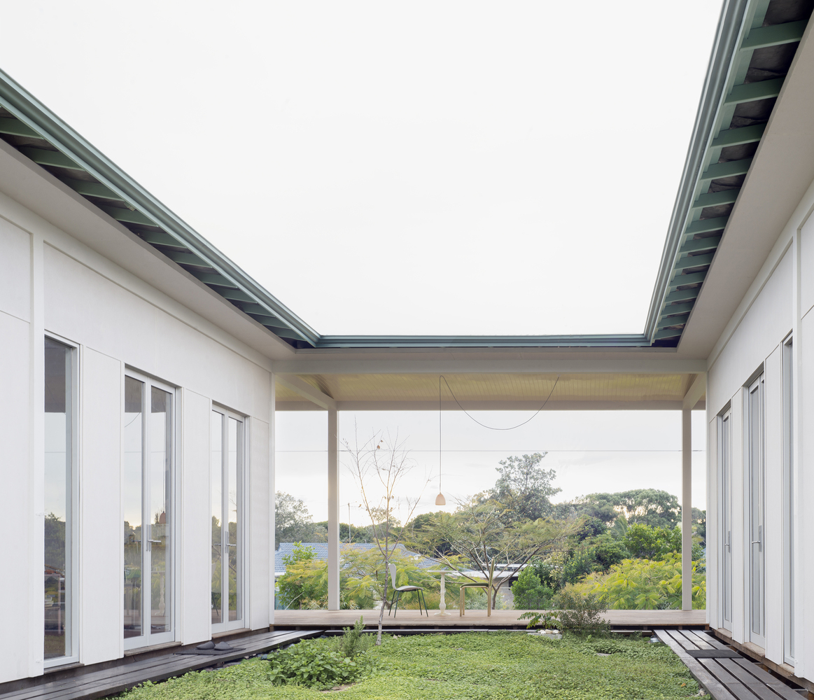 A House with a Guest Room is Created with Three Simple Pavilions